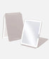 An LED vanity mirror with taupe coloured stand.