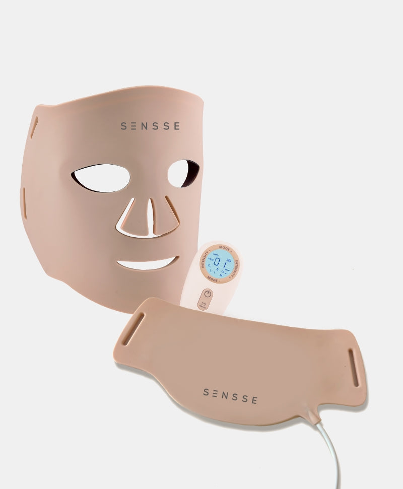 A beige coloured set of LED face and neck masks, with a white controller.